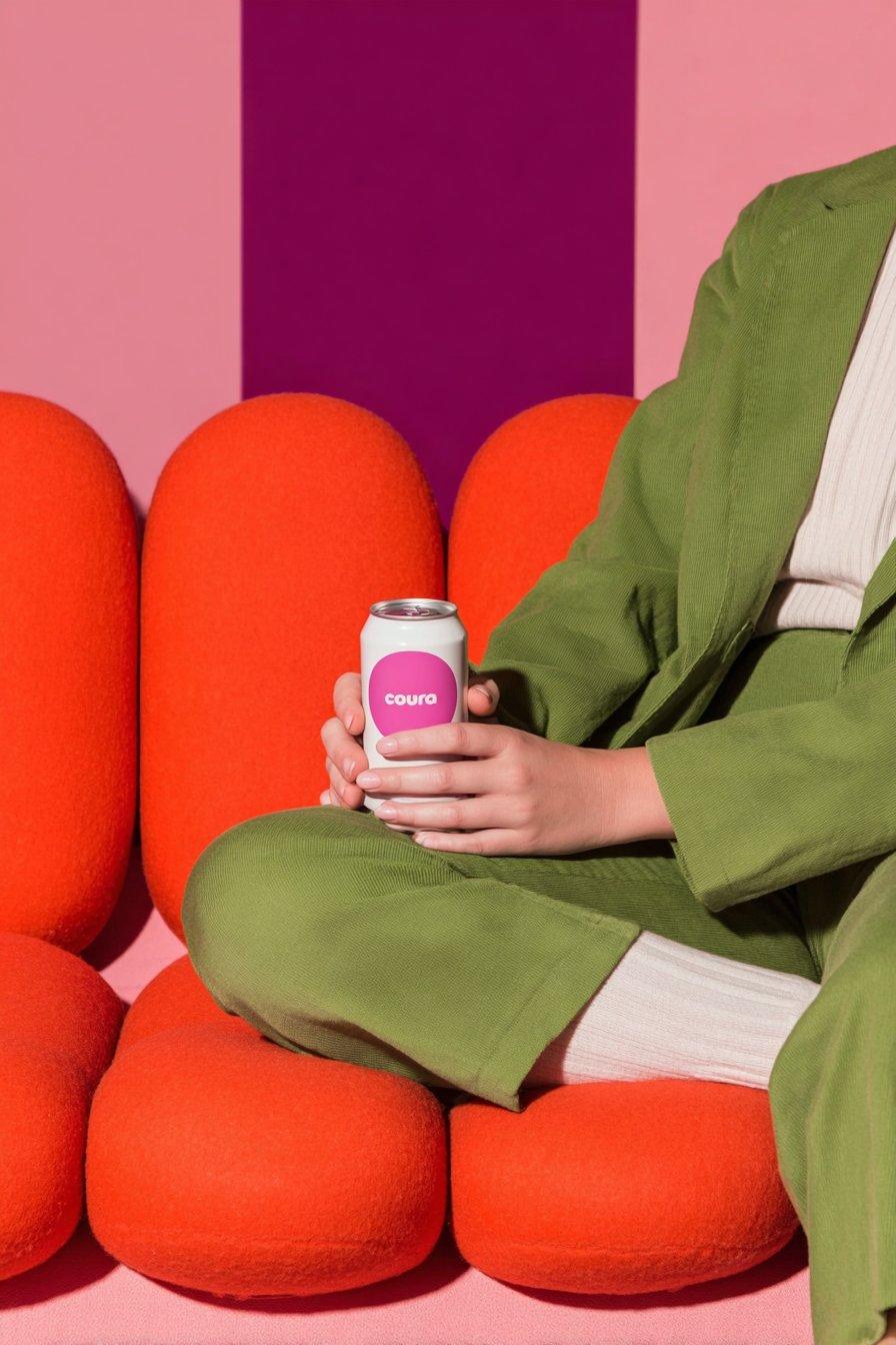 Four Nano Banana can mockups styled from the same brand reference